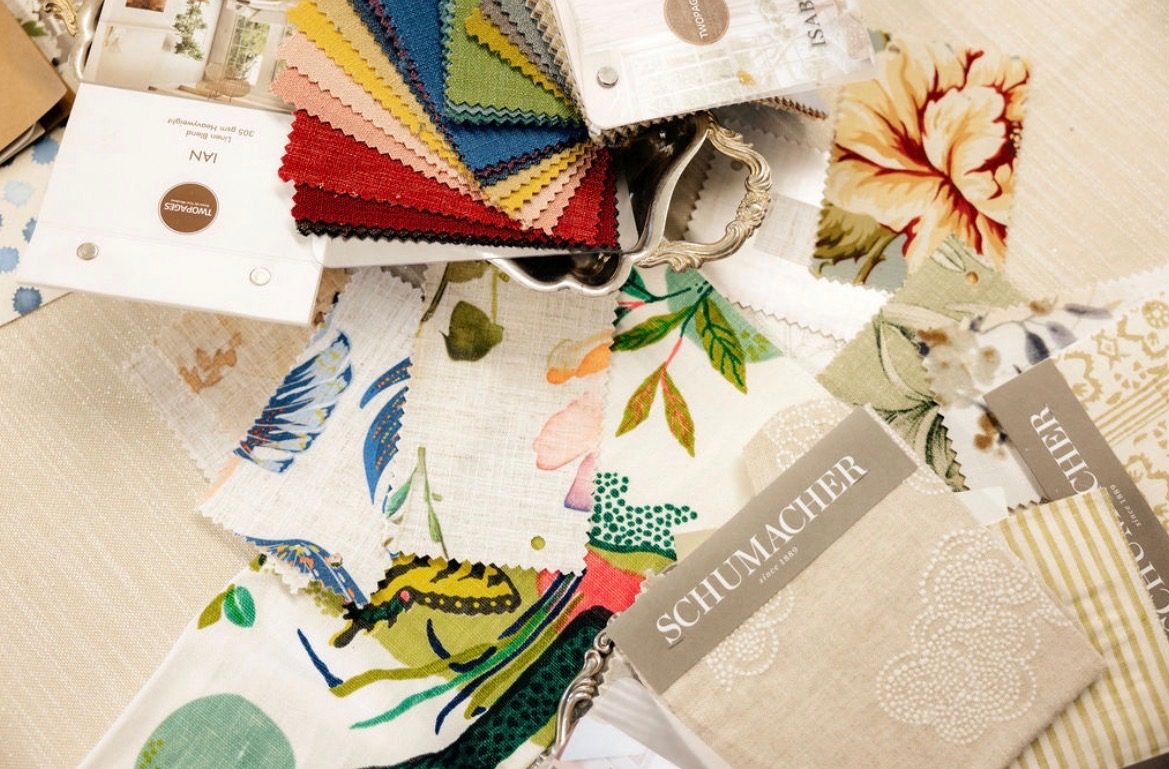 Fabric swatches spread across the table at Design Camp