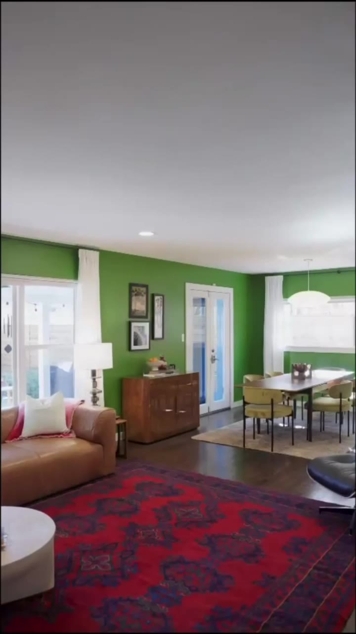 Green walls, brick and stainless kitchen, open to the living and dining space.
